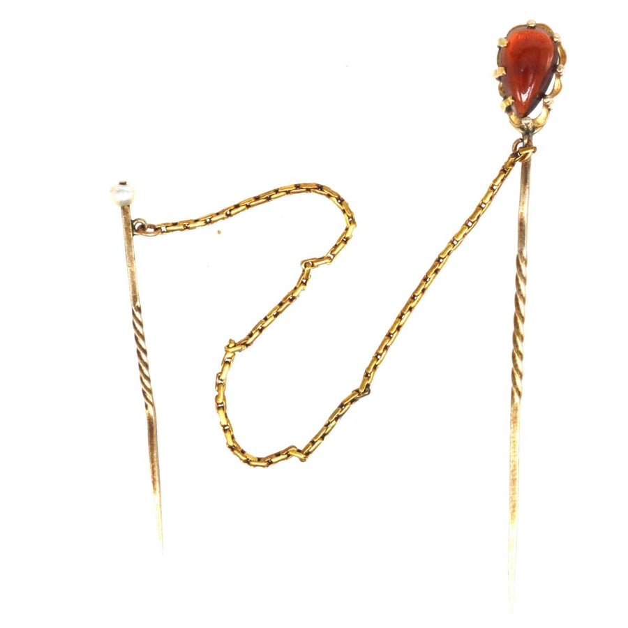 Victorian 9ct gold garnet tie pin featuring a pearl safety pin and snake chain for secure fastening.