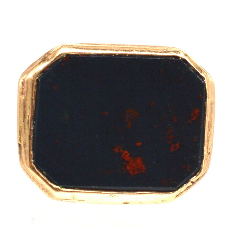 Antique 9ct gold bloodstone seal pendant with intricate design, believed to bring fortitude and protection.