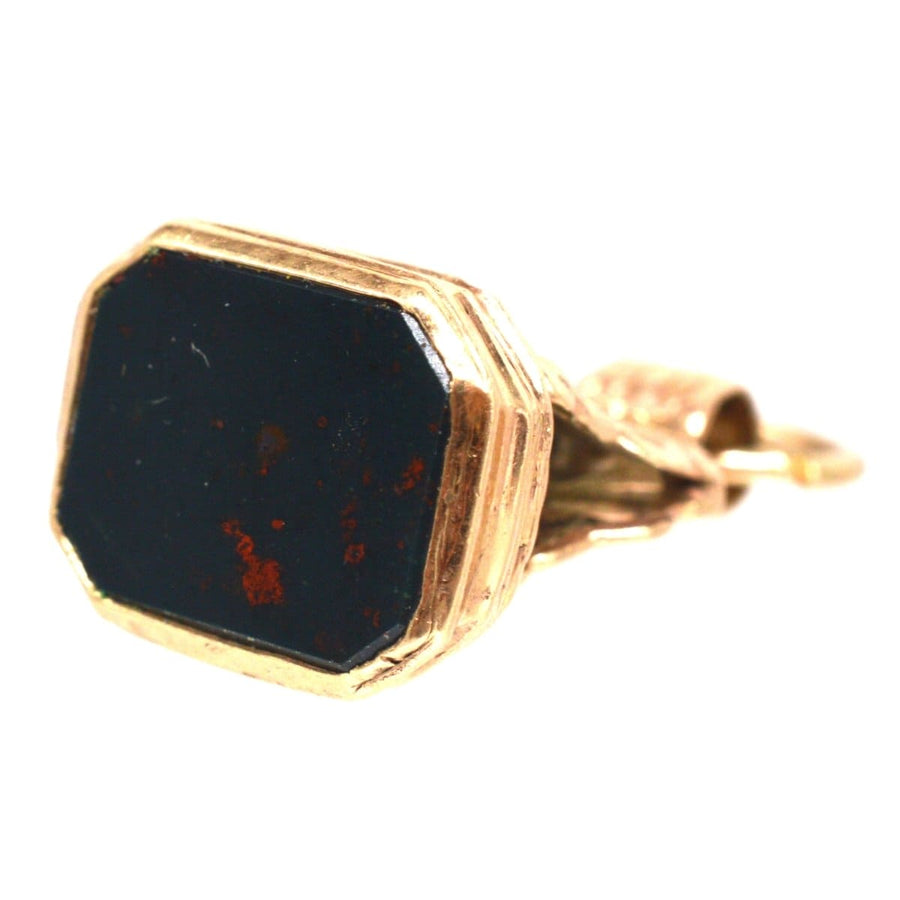 Victorian 9ct gold seal pendant featuring a scallop shell design and a bloodstone base, symbolizing bravery and protection.