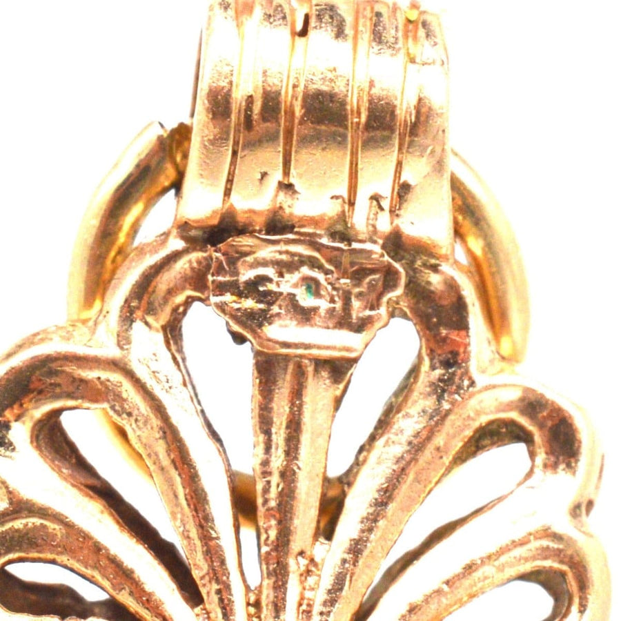 Close-up of Victorian 9ct gold scallop shell seal pendant showcasing intricate openwork design.