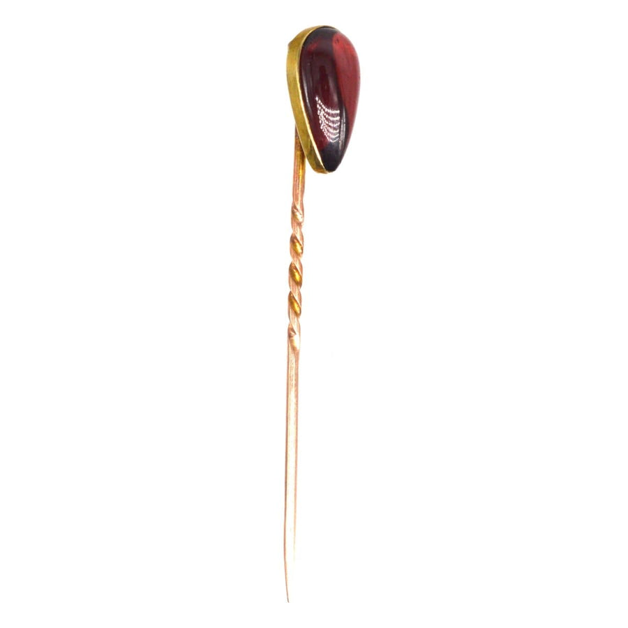 Victorian 9ct gold tie pin featuring a cabochon pear shaped garnet, crafted between 1880-1900. Perfect for January birthdays.