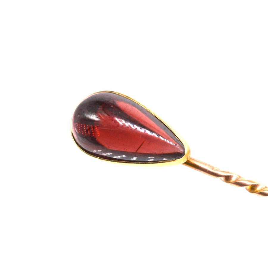 Victorian 9ct gold tie pin featuring a cabochon pear shaped garnet, a stylish accessory from 1880-1900.