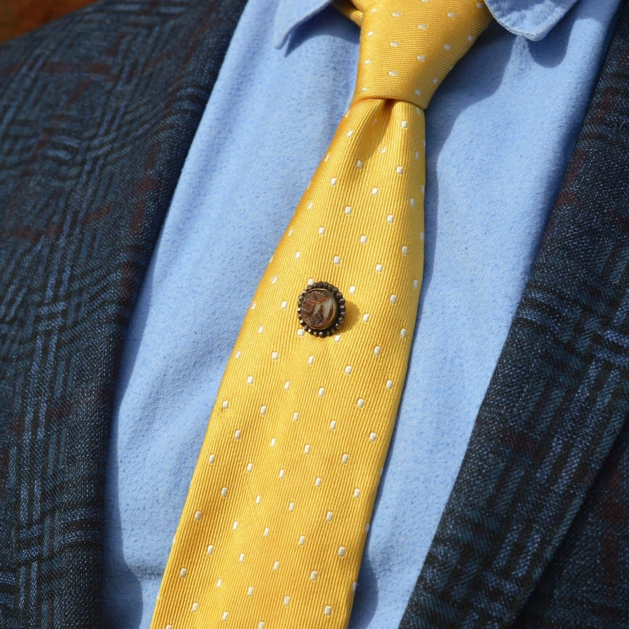19th century Victorian tie pin featuring carved brown mother of pearl on yellow polka dot tie.