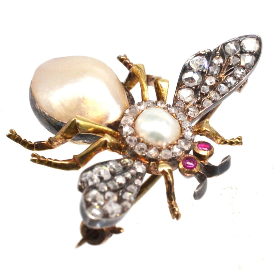 Victorian bee brooch featuring pearls, diamonds, and rubies, showcasing nature-inspired elegance.