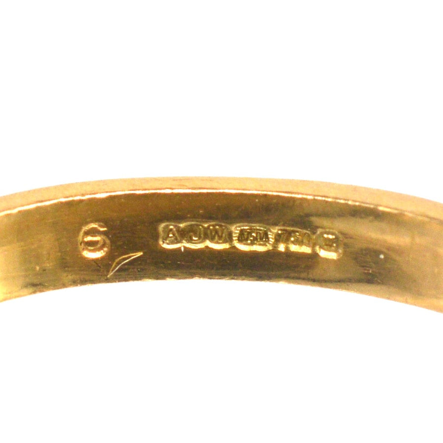 Inside view of a vintage 18ct gold ring, showcasing craftsmanship and hallmark details.