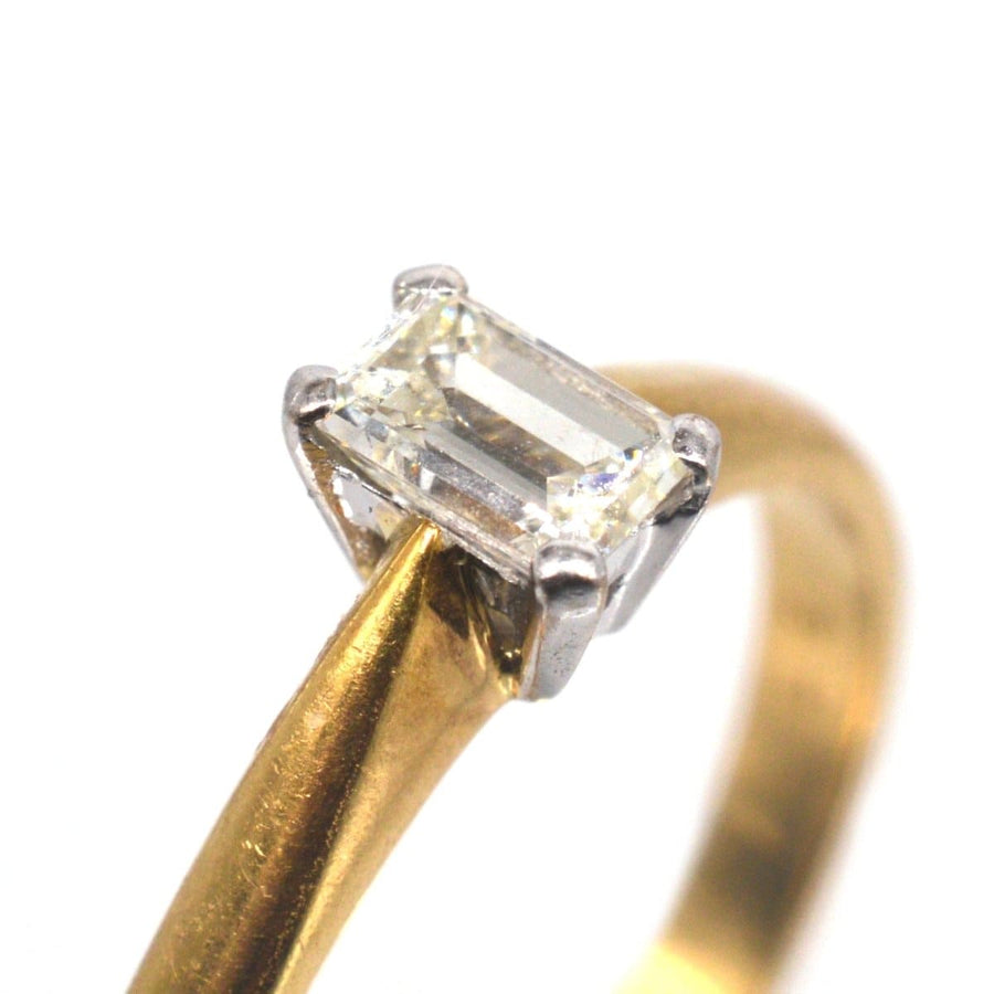 Vintage 18ct gold ring featuring an elegant emerald-cut diamond as its centerpiece, perfect for an engagement.