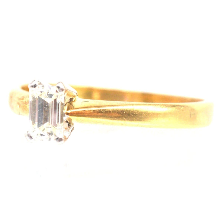 Vintage 18ct gold ring featuring an emerald-cut diamond, perfect for engagement or special occasions.