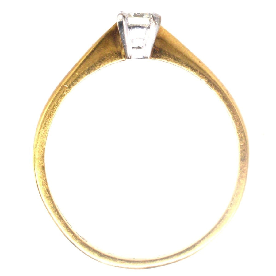 Vintage 18ct gold ring featuring a clear emerald-cut diamond, ideal for engagement or special occasions.