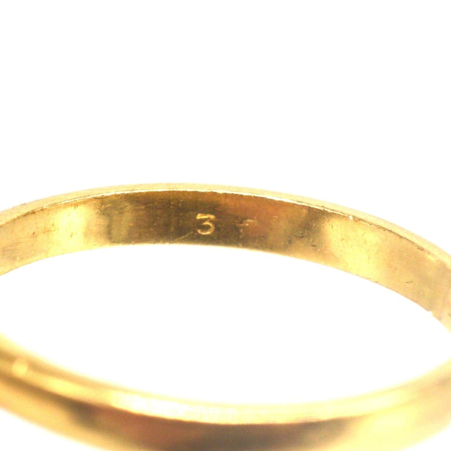Inside view of a vintage 18ct gold ring showcasing the purity mark, symbolizing quality craftsmanship.