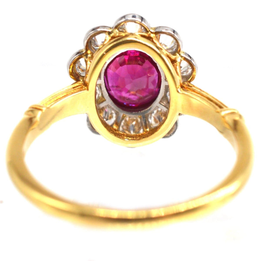 Vintage 18ct gold cluster ring featuring a Burma ruby and ten surrounding diamonds.