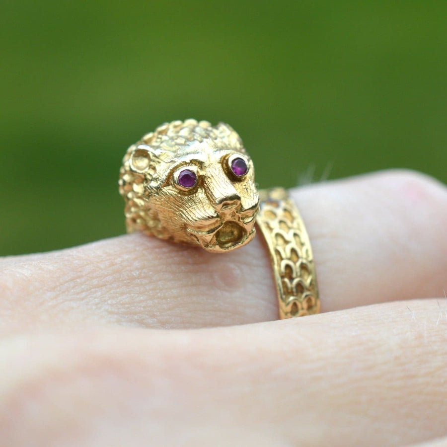 Vintage gold chimera ring featuring ruby eyes, designed in the style of Lalaounis, wrapping elegantly around a finger.