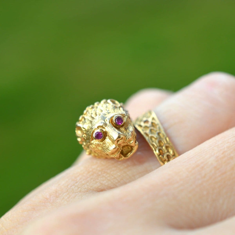 Vintage 18ct gold chimera ring featuring ruby eyes, inspired by Greek designer Lalaounis, displayed on a finger.