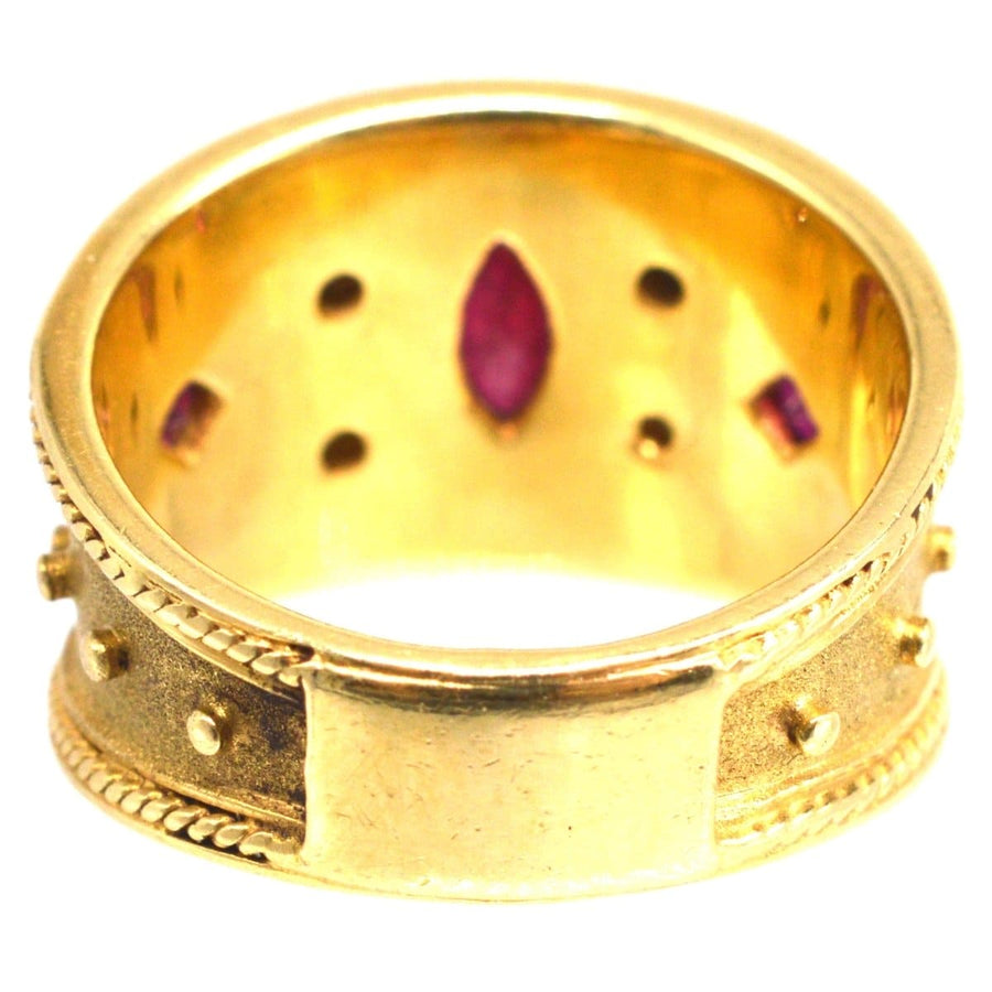 Vintage 18ct gold band ring featuring ruby inlays and intricate detailing, ideal for special occasions.