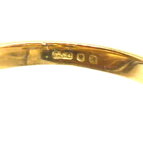 Close-up of the hallmark inside a vintage 18ct gold ring, showcasing authenticity and quality craftsmanship.