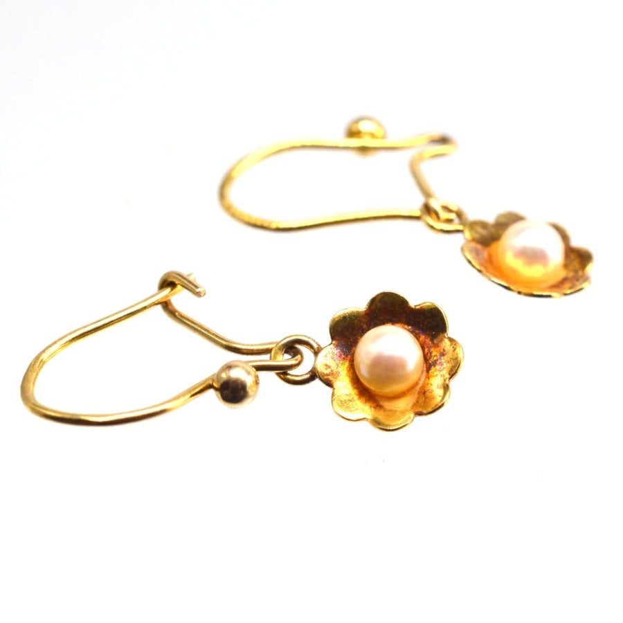 Vintage 1970s 9ct gold earrings featuring lustrous pearls in flower designs, perfect for adding charm to any outfit.