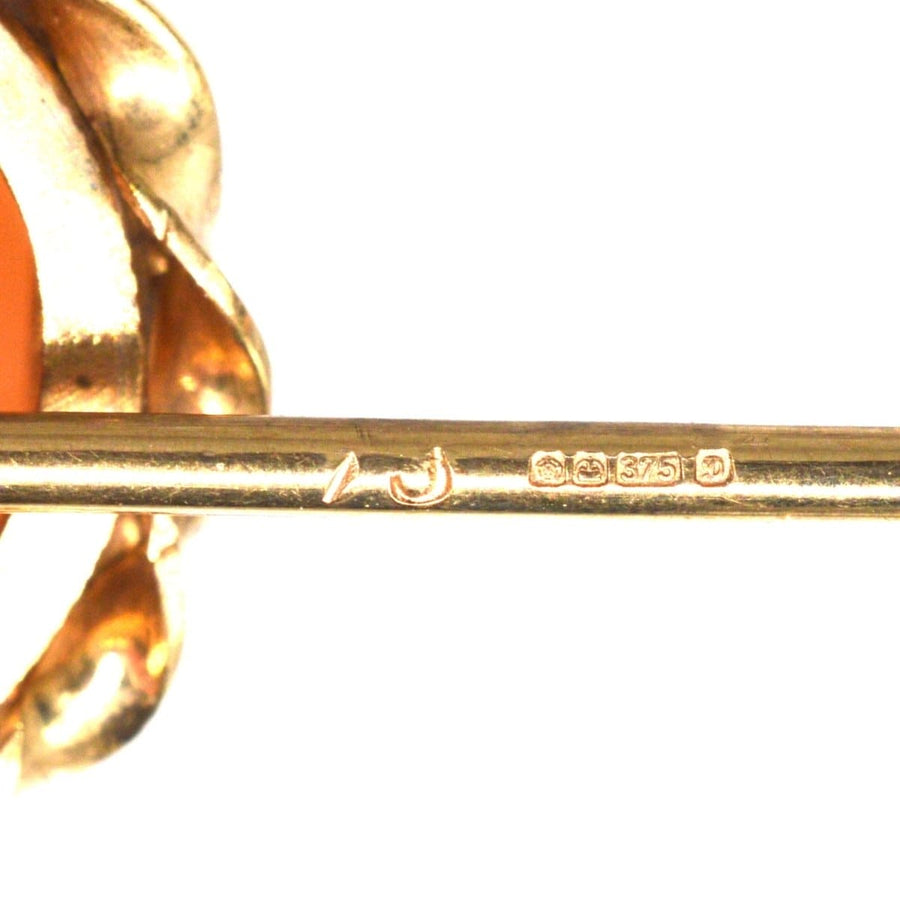Close-up of 1970s 9ct gold Victorian revival cameo tie pin, showcasing hallmark and ornate design.
