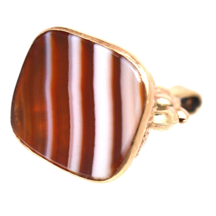Vintage 9ct gold banded agate seal pendant with a striking striped design, showcasing its antique charm.