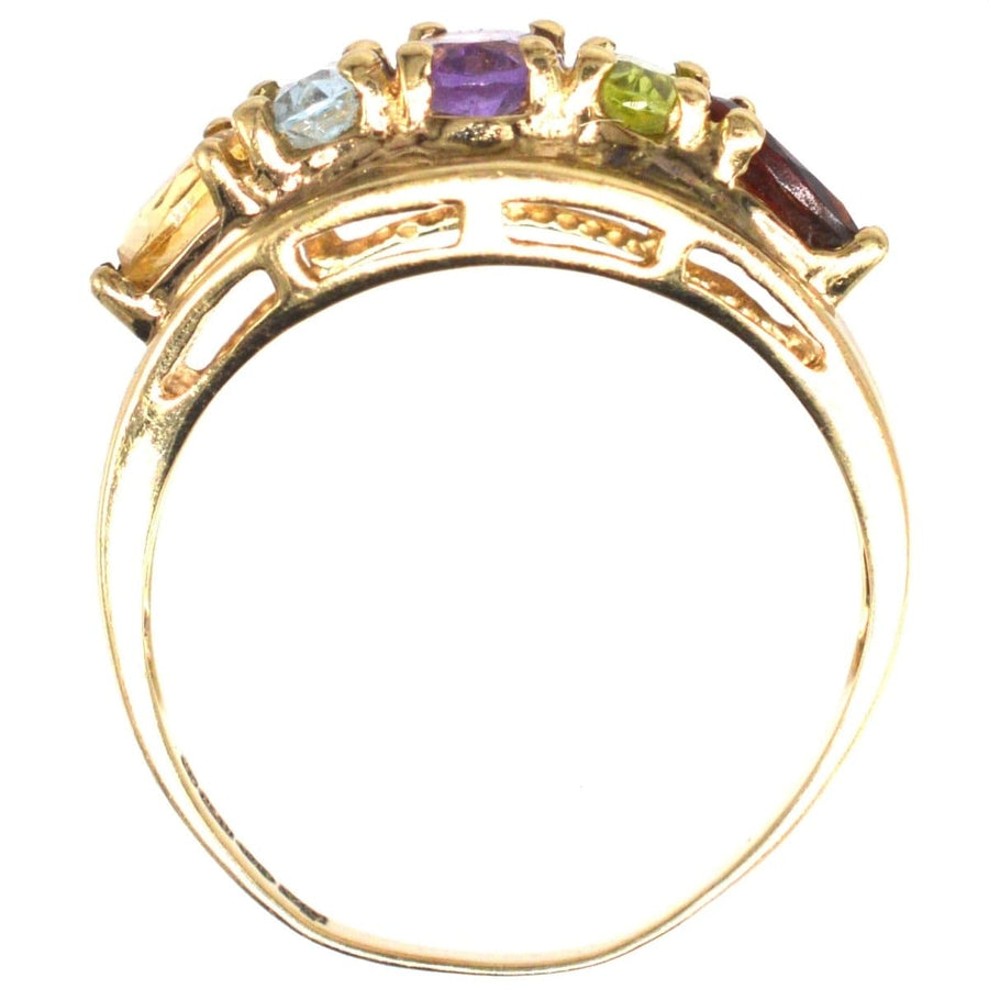 Vintage 9ct gold five stone ring featuring citrine, aquamarine, amethyst, peridot, and garnet gemstones.