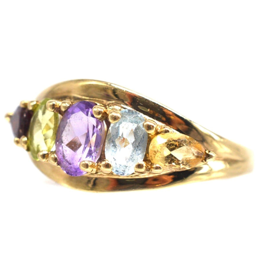 Vintage 9ct gold five stone ring featuring citrine, aquamarine, amethyst, peridot, and garnet gemstones.