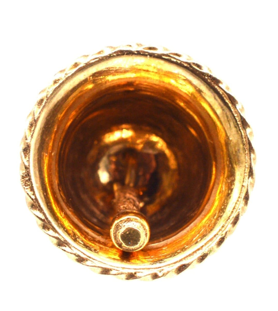 View of the interior of a vintage 9ct gold wedding ring bell charm pendant with intricate detailing.