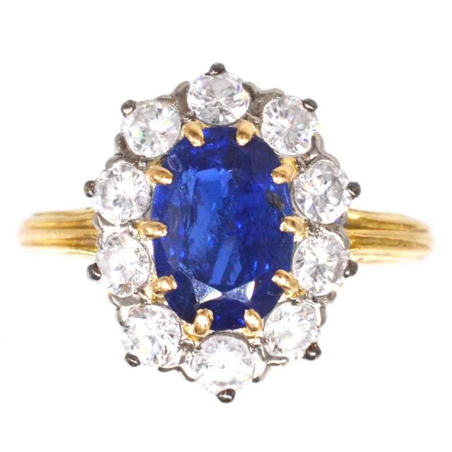 Vintage 1960s 18ct gold sapphire and diamond cluster ring with royal blue sapphire centerpiece.