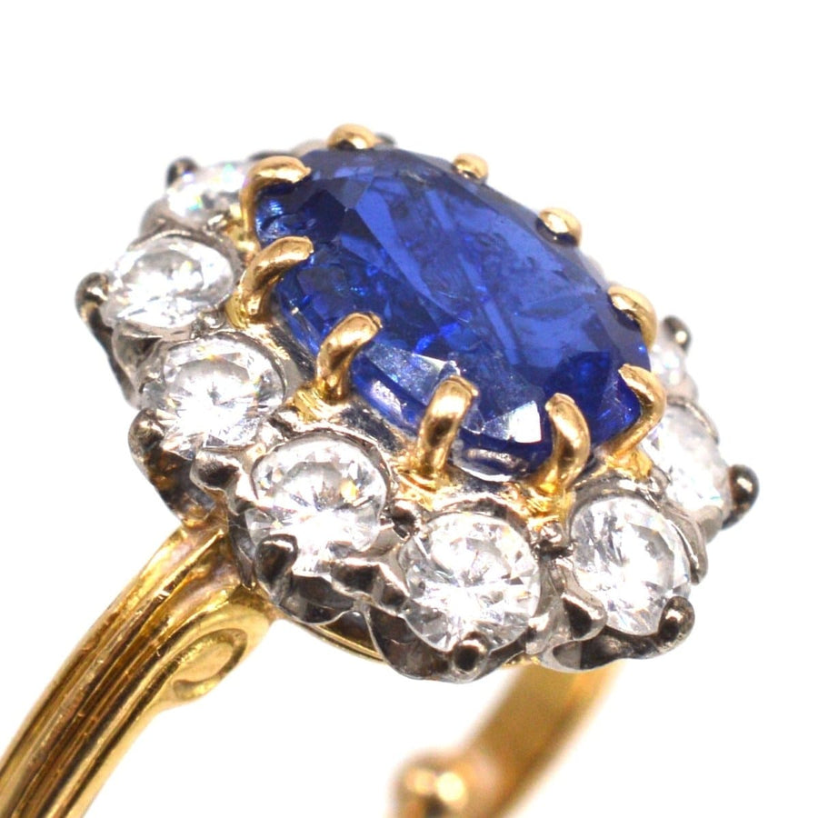 Vintage 1960s gold ring featuring a vibrant blue sapphire and diamond cluster design, perfect for engagement or September birthdays.