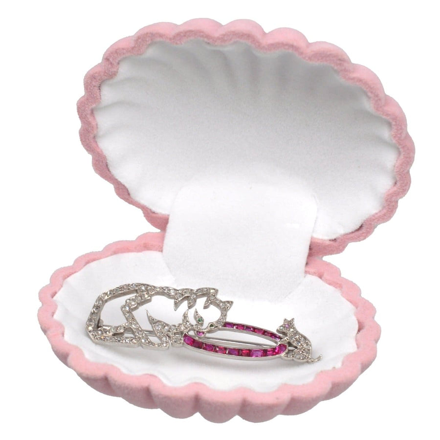 Vintage pink scallop shell jewellery display case showcasing silver and pink jewellery pieces.