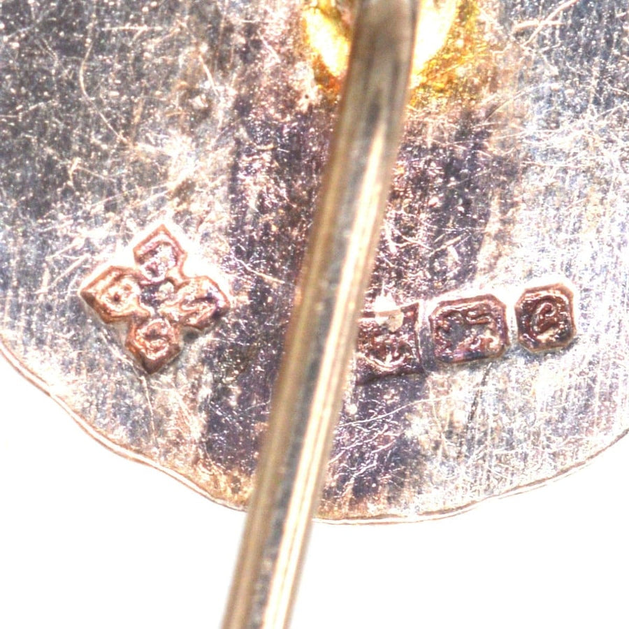 Close-up of vintage silver tie pin hallmark from Medal & Badge Co., Birmingham, featuring maker's marks and year 1977.