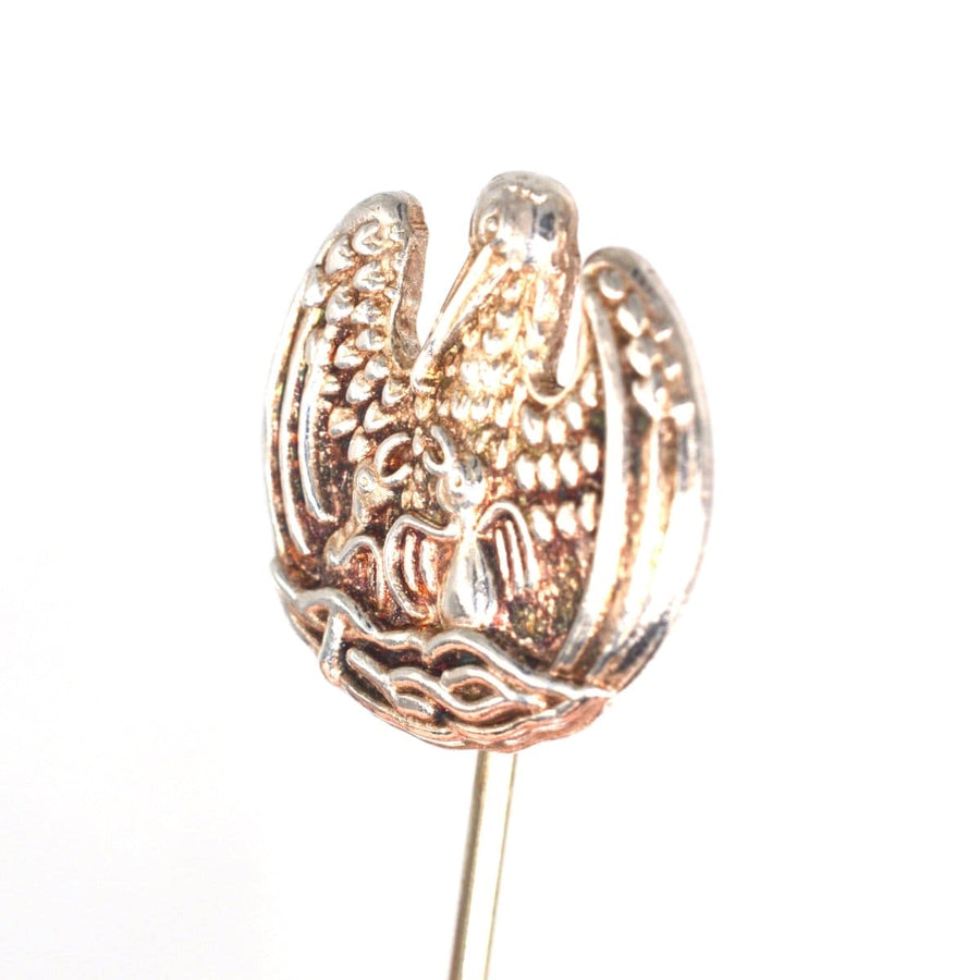 Vintage silver tie pin featuring the pelican in her piety, symbolizing sacrifice and motherly selflessness.