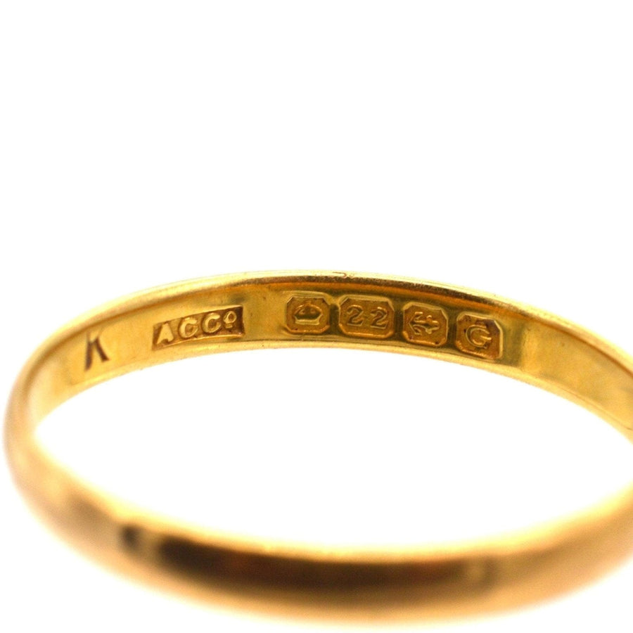 Close-up of a 1930s 22ct gold wedding ring showing hallmark details and authenticity. Perfect for lovers of vintage jewelry.