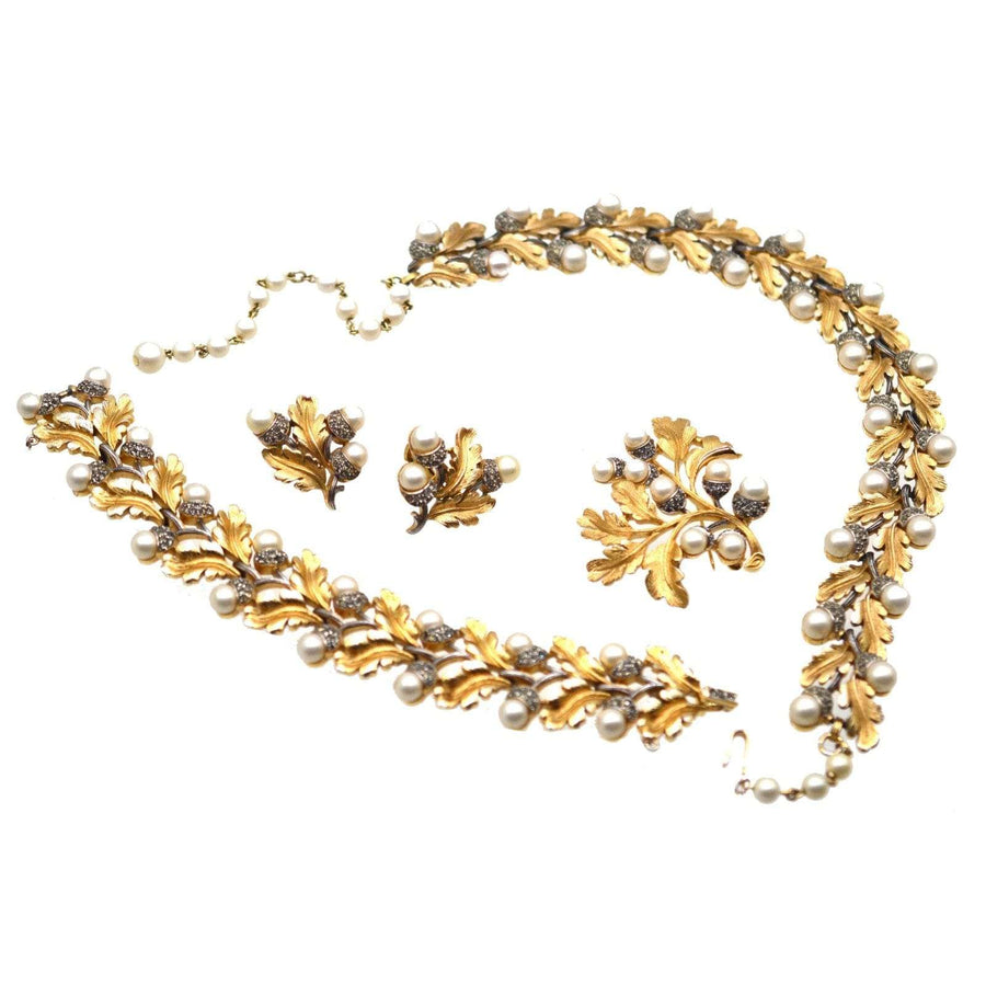 1950s Trifari gold-tone oak leaf jewelry set with faux pearls, including necklace, bracelet, earrings, and brooch.