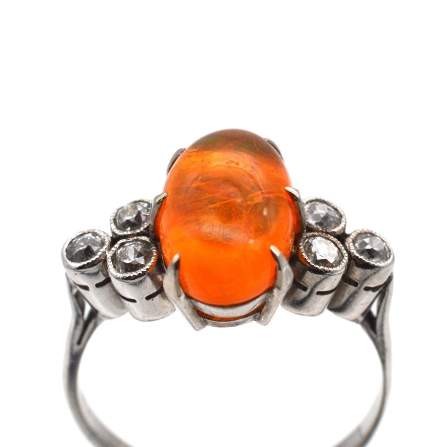 1960s Boodles platinum ring featuring a natural fire jelly opal and diamond accents.