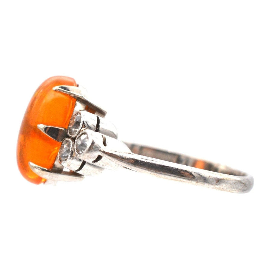 1960s Boodles platinum ring featuring a stunning fire opal and diamond accents, showcasing vibrant orange hues.