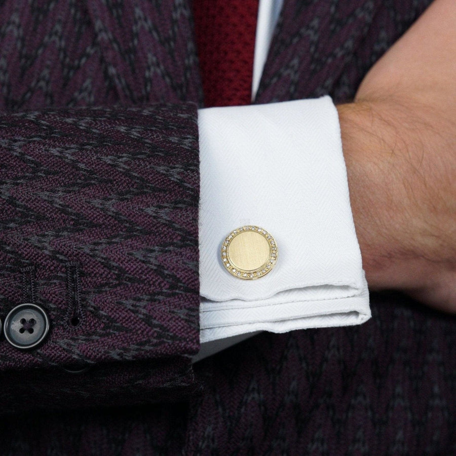 Elegant 1980s gold and diamond cufflink on a man's shirt cuff, showcasing classic style and sophistication.