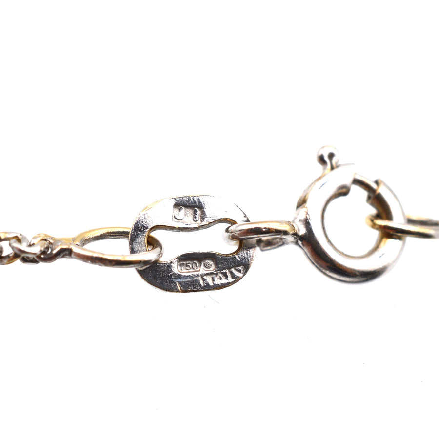 Close-up of an 18ct white gold chain clasp for a vintage diamond cross pendant.
