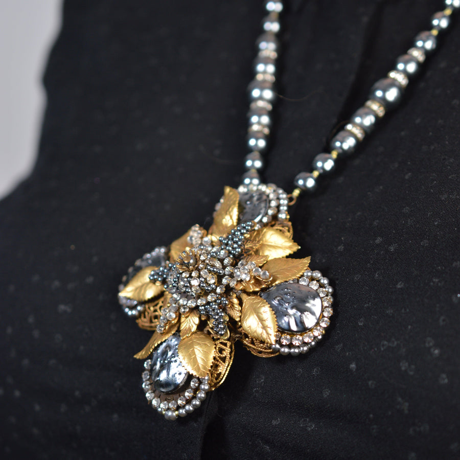 Mid Century Miriam Haskell gold gilt and rhinestone necklace with a cross pendant and black pearl beads.