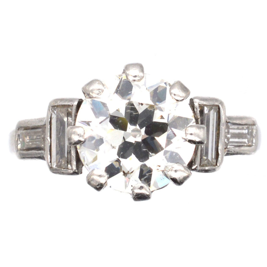 Large Art Deco platinum ring featuring a 3 carat Old European cut diamond and baguette diamond shoulders.