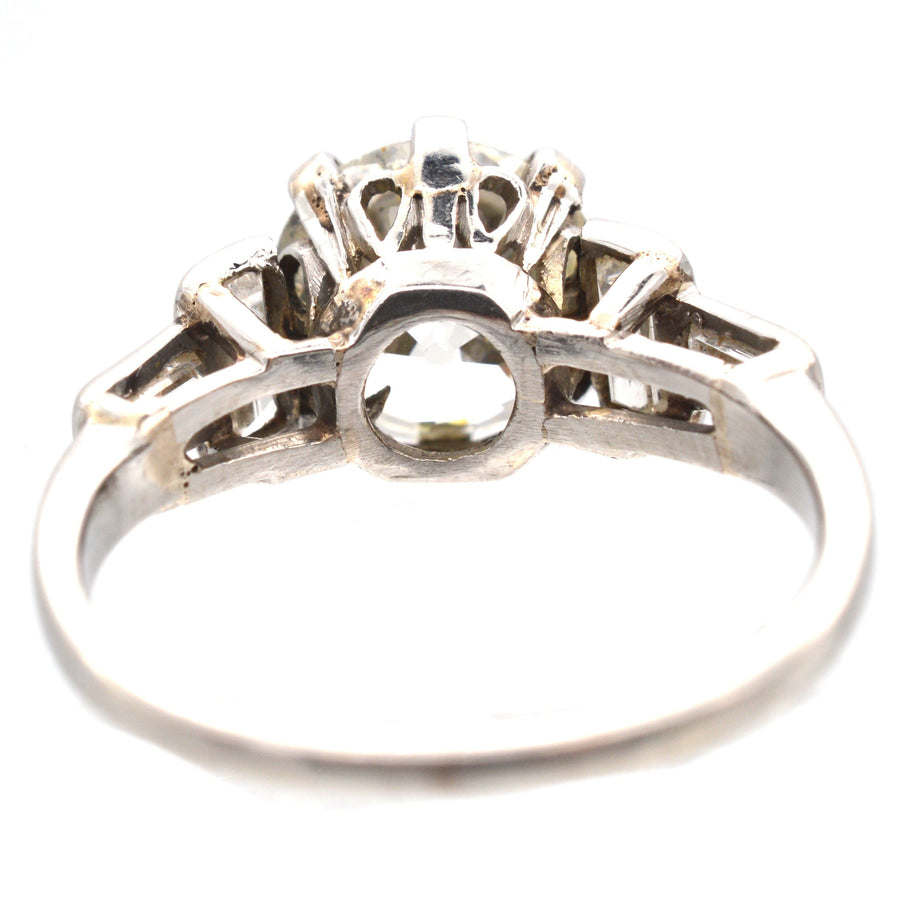 View of a large Art Deco platinum ring featuring a 2.3 carat diamond and baguette diamond shoulders.