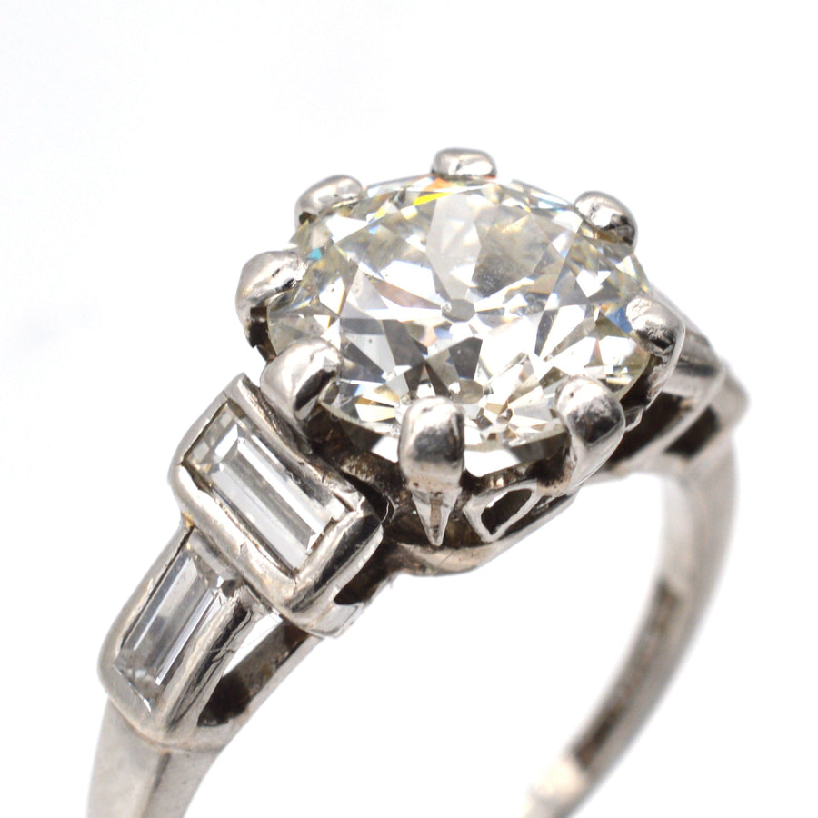 Large Art Deco platinum ring with 3 carat old European cut diamond and baguette diamond shoulders.