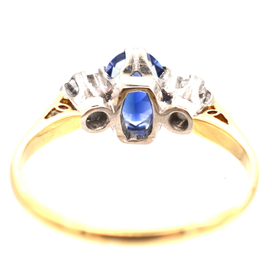 Art Deco 18ct gold ring featuring a large sapphire and two diamonds, perfect as an engagement ring.