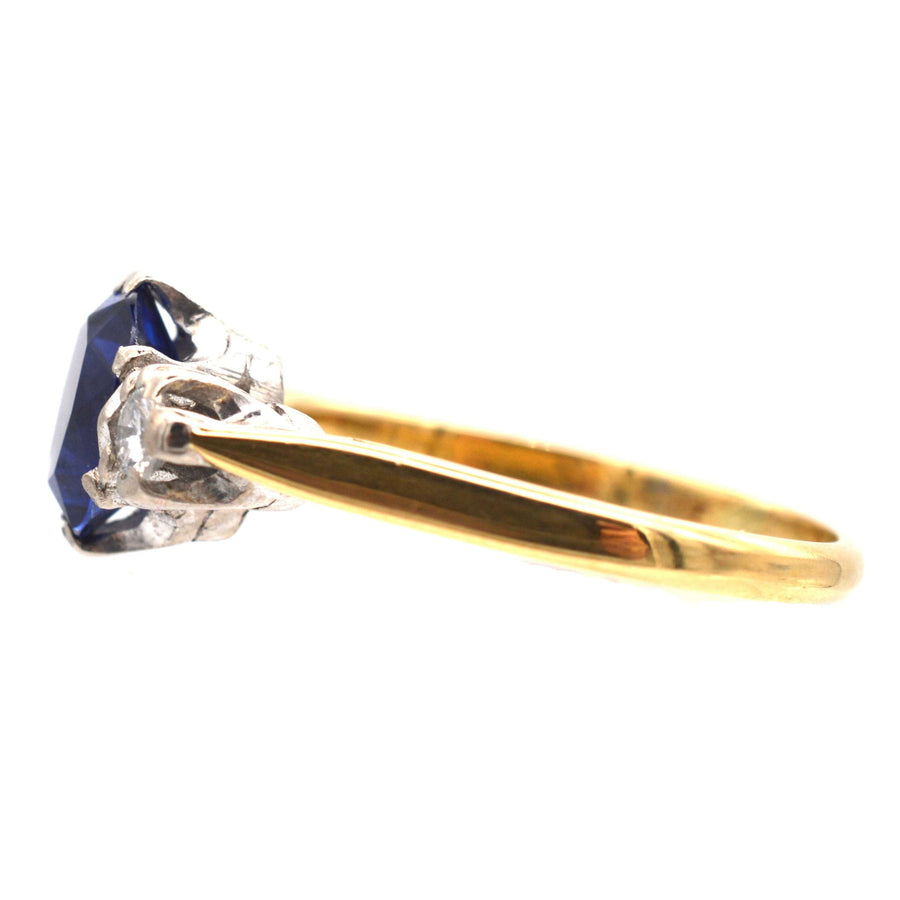 Art Deco 18ct gold ring featuring a large sapphire and two diamond stones, perfect for an engagement.