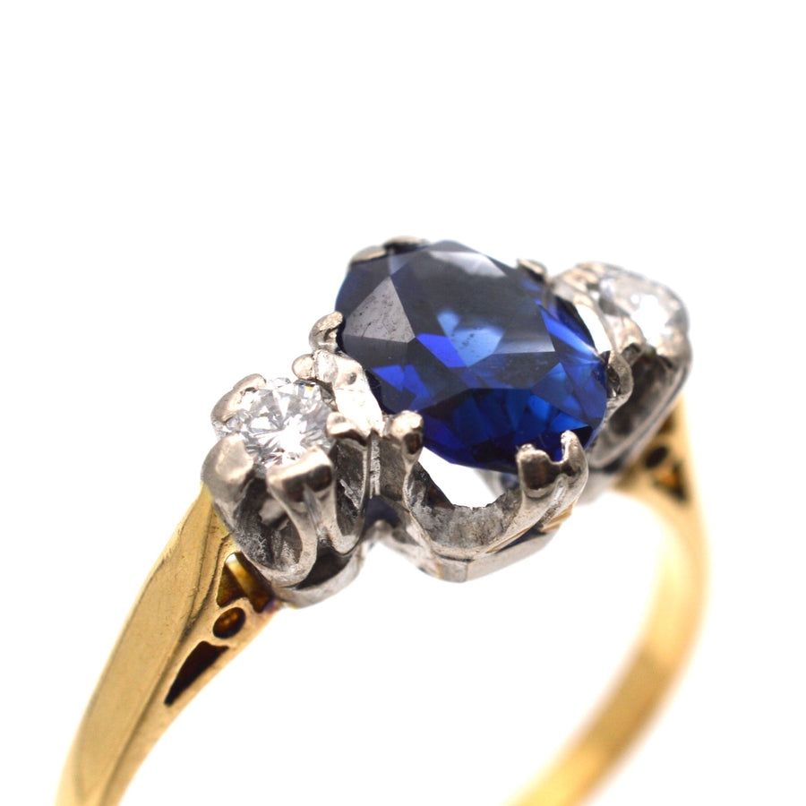 Art Deco 18ct gold sapphire and diamond three stone ring, featuring a large blue sapphire and two white diamonds.