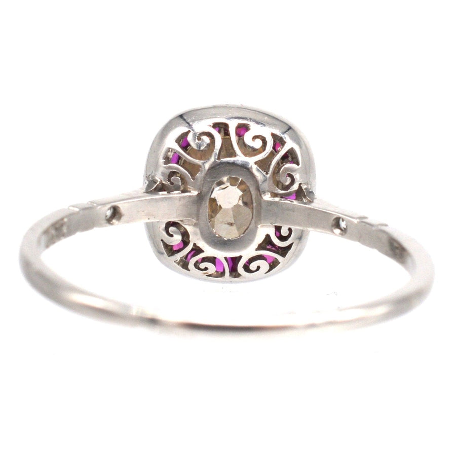 American Art Deco platinum ring featuring a champagne diamond and ruby accents in intricate design.