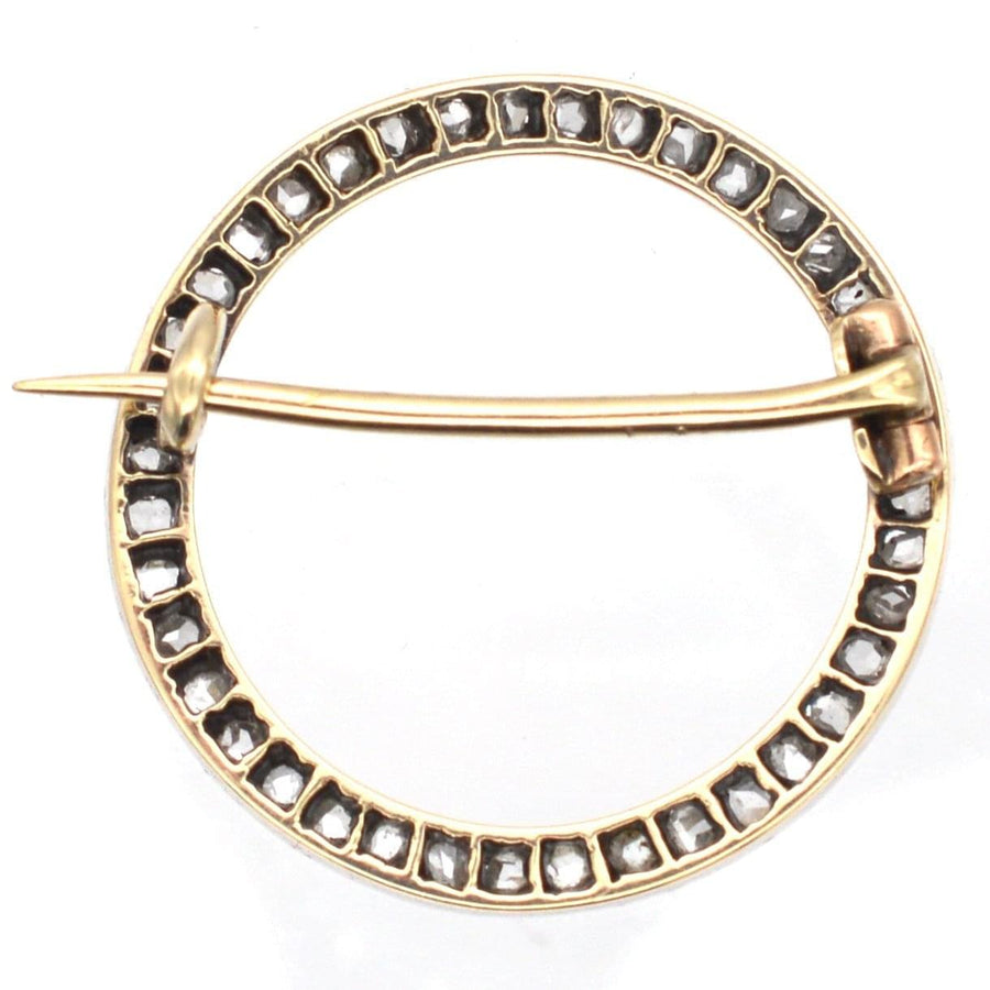 Art Deco brooch in 15ct gold and platinum with rose cut diamonds, featuring a circular design typical of the era.