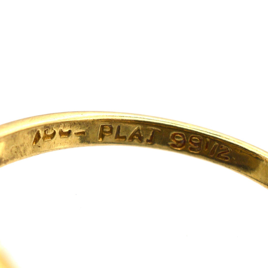 Close-up of an 18ct gold ring interior with engraving showing platinum and gold content details.