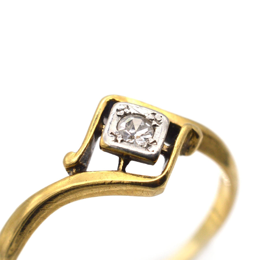 Art Deco 18ct gold and diamond solitaire twist ring from the 1920s with an elegant diamond frame.