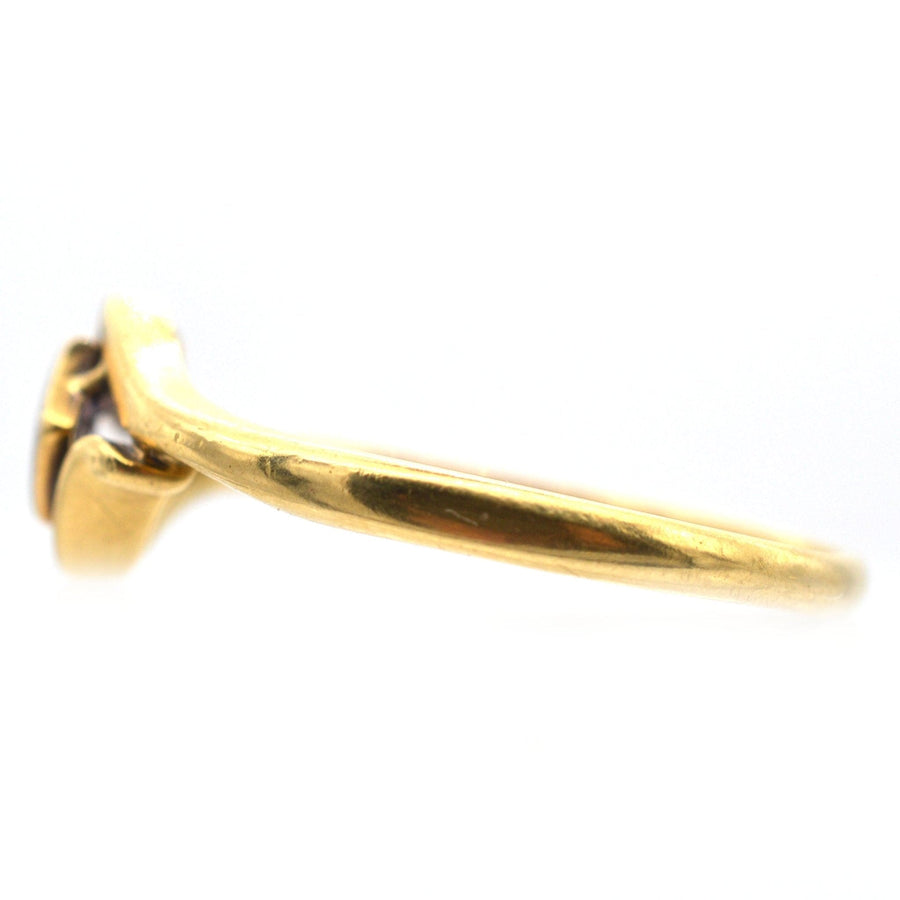 Side view of an Art Deco 18ct gold diamond solitaire twist ring with an elegant frame.
