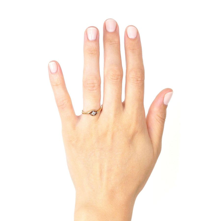 Hand wearing a vintage Art Deco 18ct gold diamond twist ring with star motif, showcasing exquisite craftsmanship.