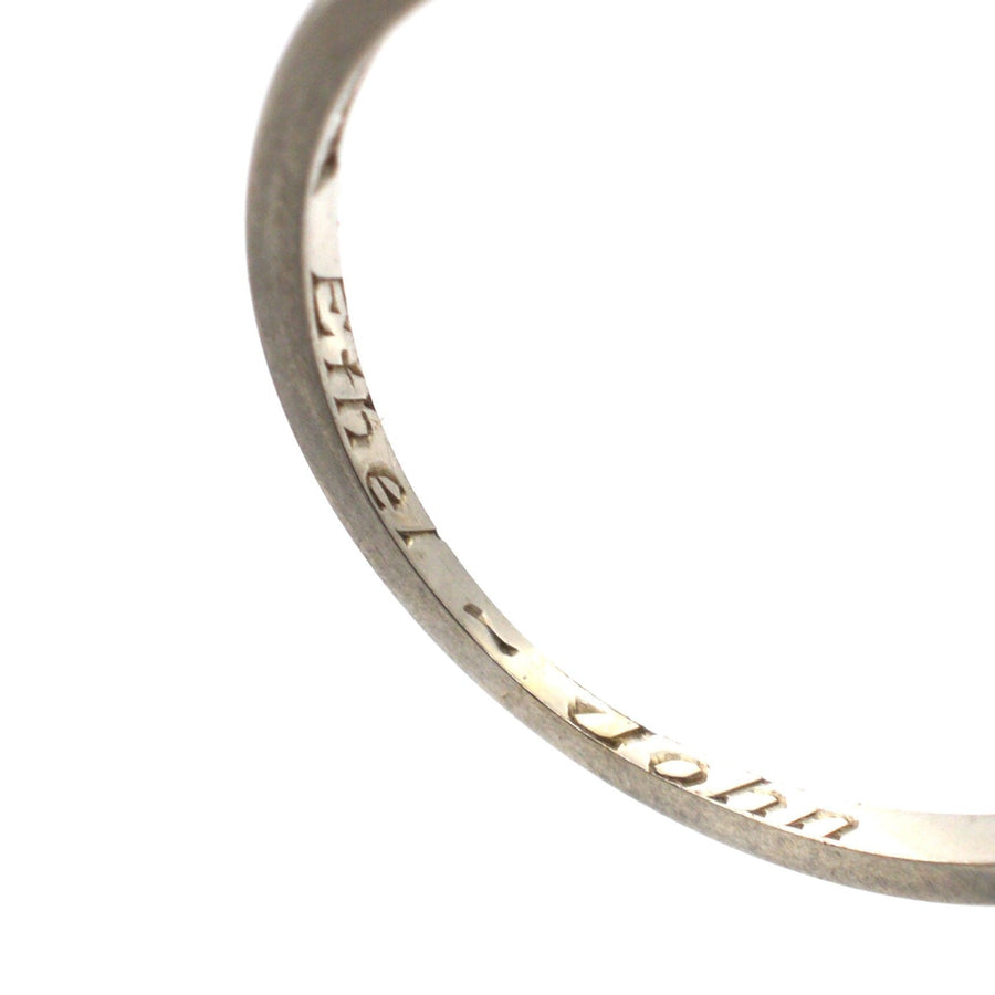 Close-up of engraved inside of Art Deco 18ct Gold ring, featuring the inscription 'Ethel - John', showcasing craftsmanship.