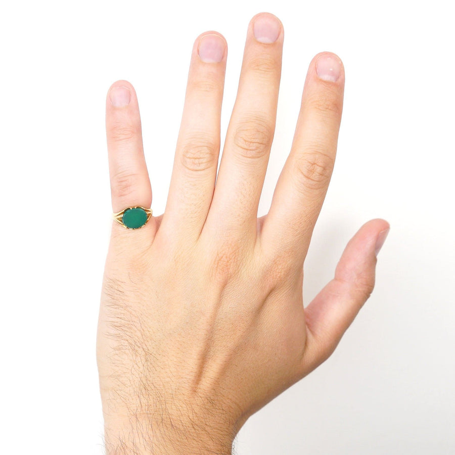 Art Deco 18ct gold signet ring with green chalcedony displayed on a hand, showcasing unique design and rich color.